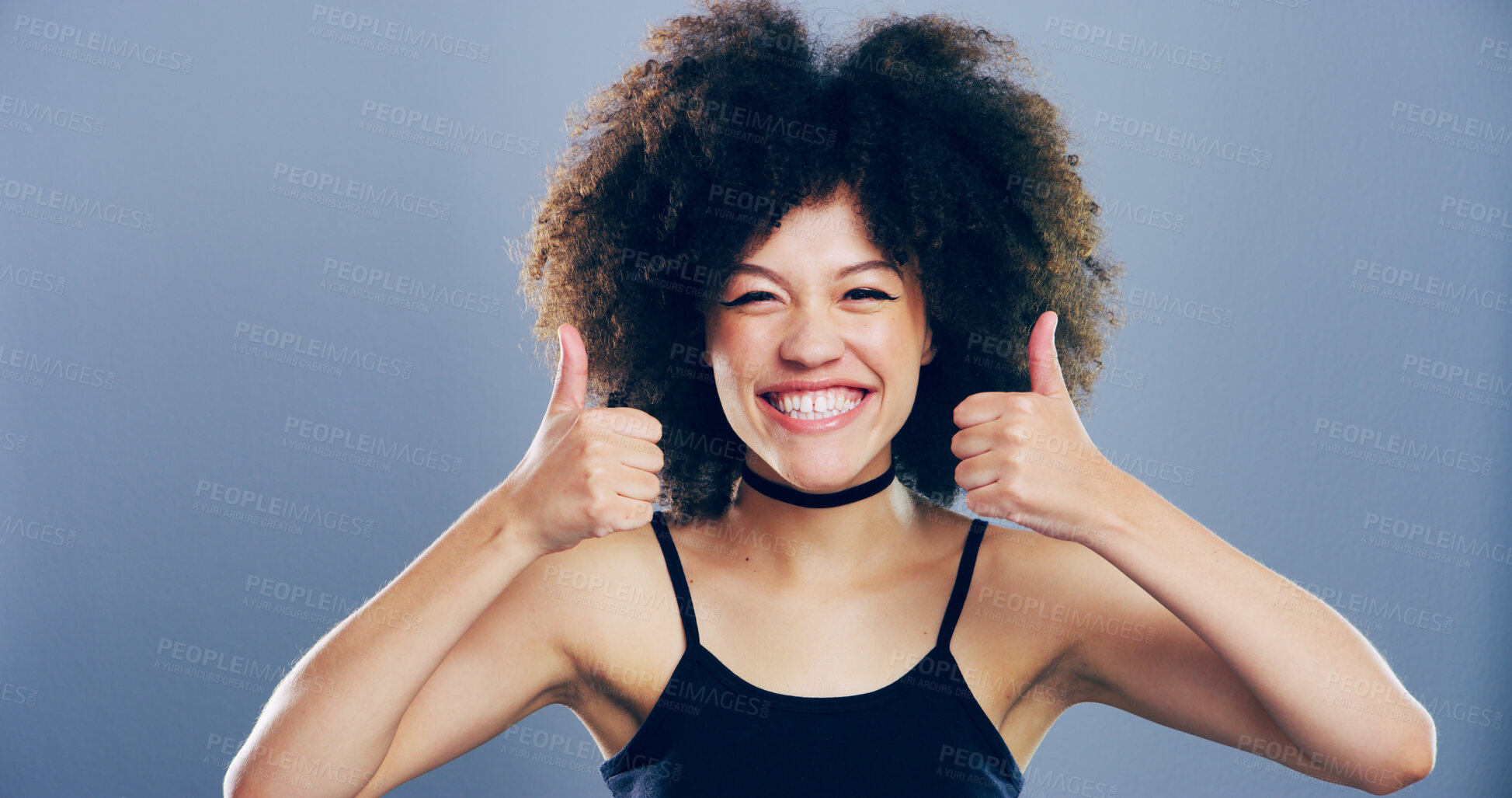 Buy stock photo Thumbs up, happy and portrait of woman in studio with support, agreement or success emoji. Excited, face and female person from Portugal with approval or thank you hand gesture by gray background.