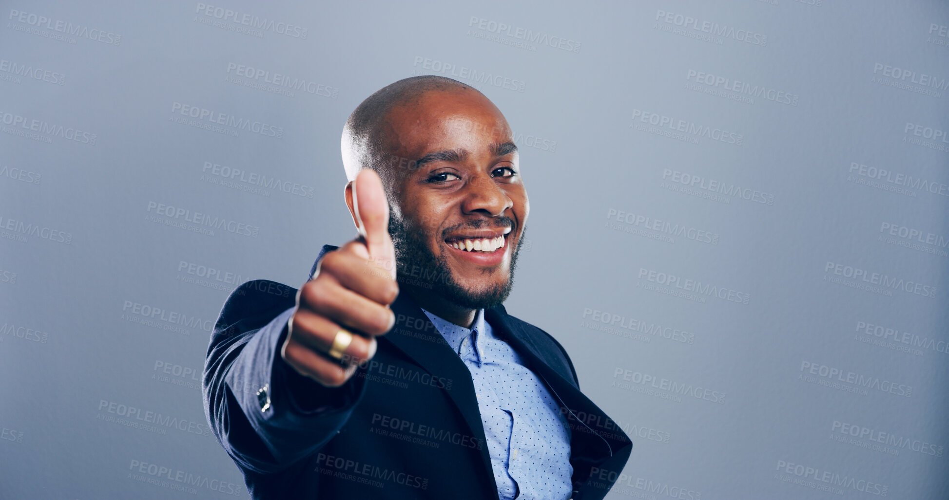 Buy stock photo Happy, black man and portrait with thumbs up for business success or approval on a gray studio background. Face, businessman or model with smile, like emoji or yes sign for winning on mockup space