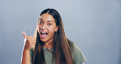 Buy stock photo Thumbs up, excited and portrait of woman in studio with support, agreement or success emoji. Happy, face and female person from Colombia with approval or thank you hand gesture by gray background.