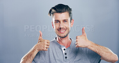Buy stock photo Happy man, portrait and thumbs up in studio for success or approval emoji on a gray background. Face, male person or model with smile, like hand gesture or yes sign for winning on mockup space