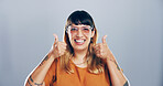 Thumbs up, feedback and portrait of woman in studio with support, agreement or success emoji. Excited, face and female person from Mexico with approval or thank you hand gesture by gray background.