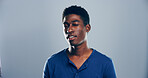 Black man, symbol and wink in studio portrait, sign and emoji with secret for flirting by background. Person, model and happy with icon, style and face with confidence by space with pride in Kenya
