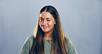Studio, woman and portrait with smile for wink, emoji expression and carefree model with flirting. Female person, happy and confidence with personality, secret and mockup space by gray background