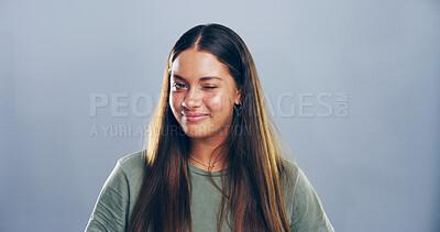 Buy stock photo Studio, woman and portrait with smile for wink, emoji expression and carefree model with flirting. Female person, happy and confidence with personality, secret and mockup space by gray background