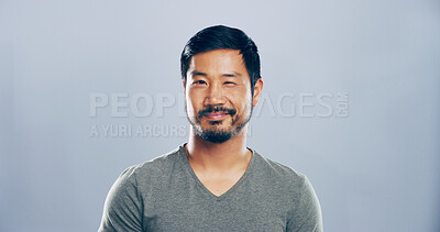 Buy stock photo Studio, man and portrait with smile for wink, emoji expression and carefree model with flirting. Male person, confidence and goofy with funny personality, secret and mockup space by gray background