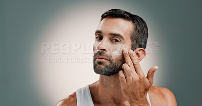 Buy stock photo Application, face cream and portrait of man in studio for wellness, health and hydration for facial care. Dermatology, beauty and person with lotion, moisturizer or skincare on gradient background