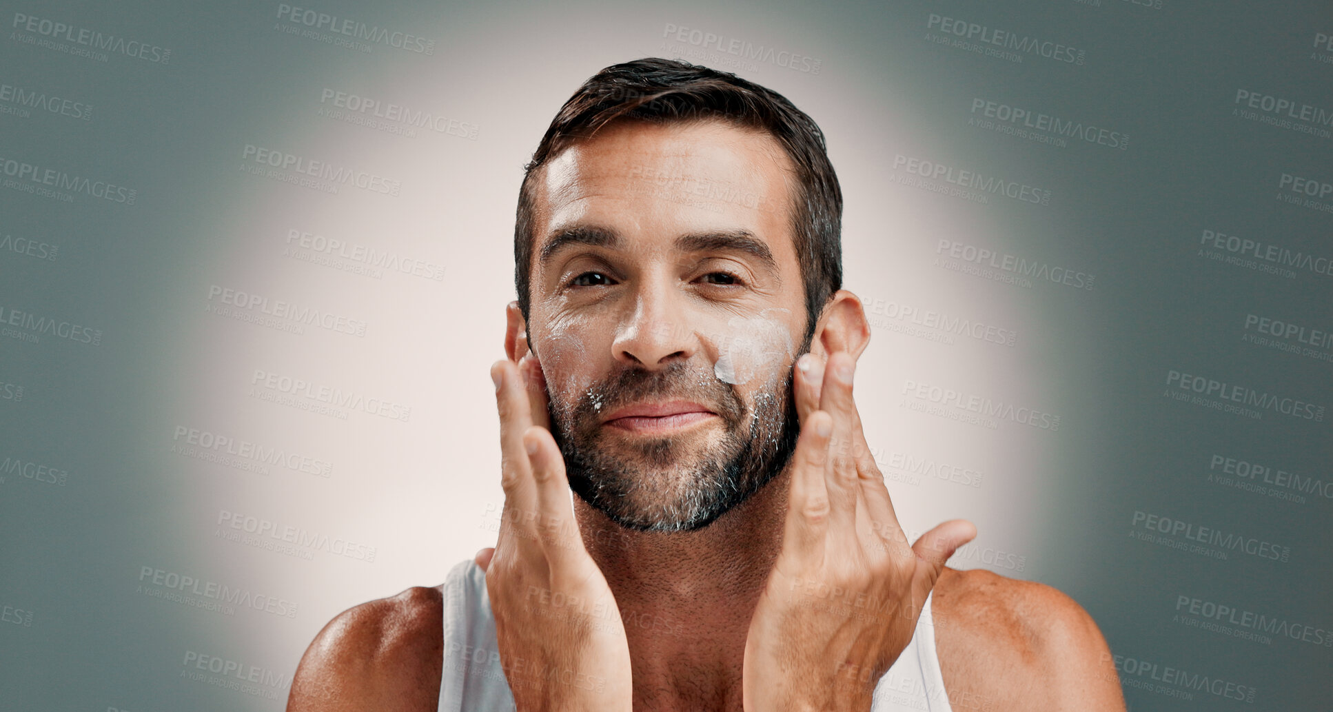 Buy stock photo Washing, soap and portrait of happy man in studio for wellness, cleaning and facial treatment. Dermatology, beauty and person with cream, moisturizer and skincare cosmetics on gradient background