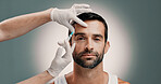 Collagen, injection and plastic surgery with portrait of man in studio for change or transformation. Face, hands of doctor and syringe with patient on gray background for cosmetic surgery or facelift