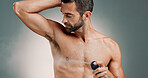 Spray, armpit and hygiene for man, studio and wellness for skin with deodorant, skincare or smell. Gray background, cosmetics and bodycare for underarm with fragrance, grooming or person with product