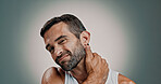 Neck pain, stress and portrait of man in studio with injury, tension and inflammation on gradient background. Frustrated, health and person with massage for muscle strain, medical risk and pressure