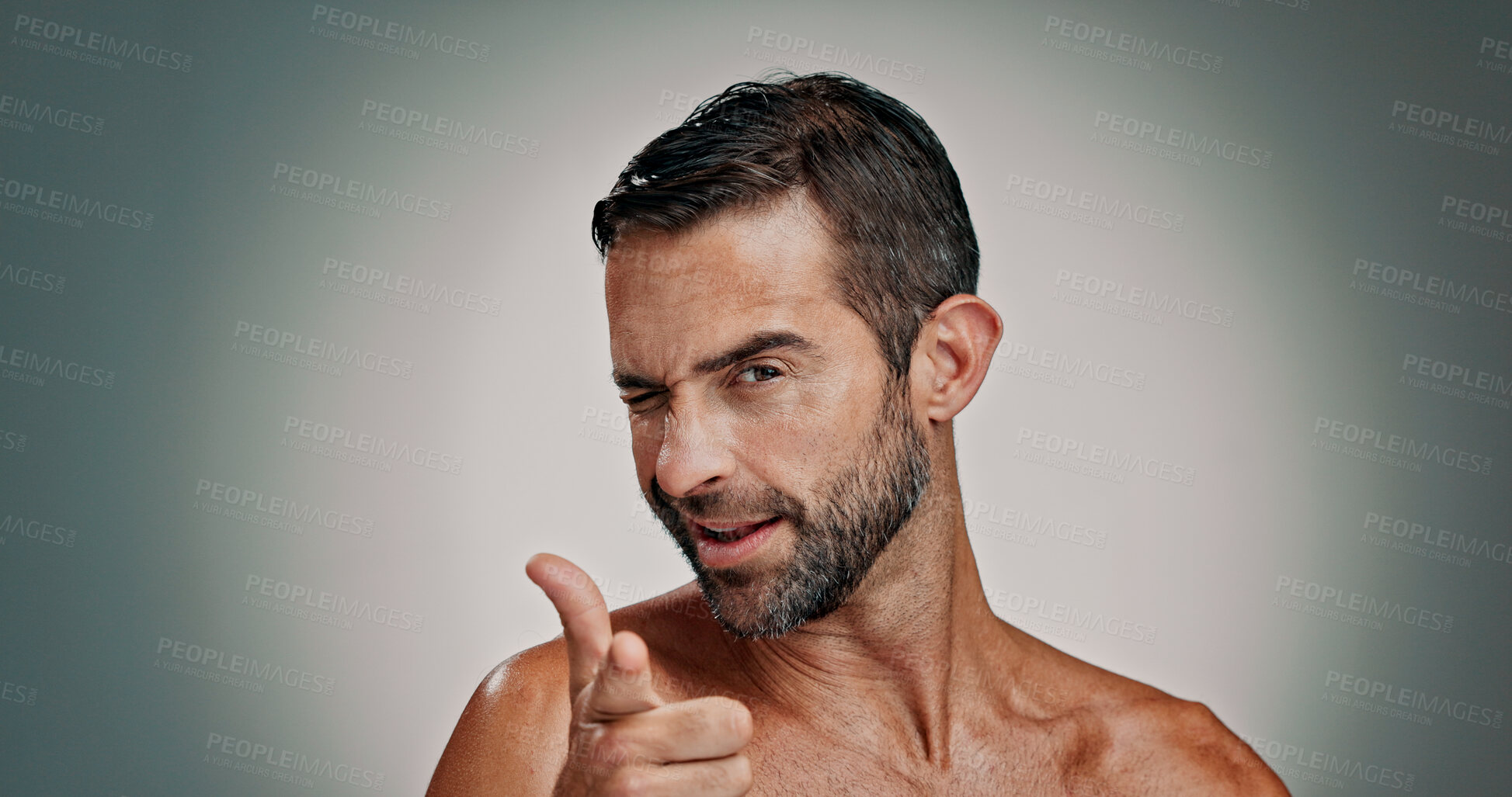 Buy stock photo Skincare, wink and portrait of man in studio pointing to you for facial, beauty and wellness. Health, dermatology and person with choice gesture for cosmetics, grooming and spa on gradient background