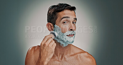 Buy stock photo Shaving, cream and grooming with portrait of man in studio for beard, beauty and cleaning. Hair removal foam, cosmetics and self care with person and brush on background for hygiene and skincare
