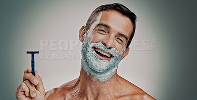 Buy stock photo Shaving, cream and razor with portrait of man in studio for beard grooming, beauty and cleaning. Hair removal foam, cosmetics and self care with person on background for hygiene, skincare and salon