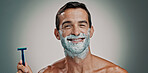 Shaving, cream and portrait of man in studio for beard grooming, beauty and cleaning. Hair removal foam, cosmetics and self care with person and razor on background for hygiene, skincare and salon