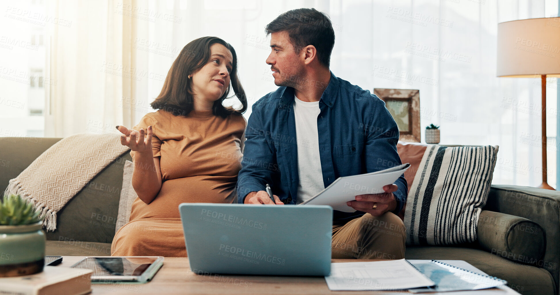Buy stock photo Pregnant woman, couple and documents for finance in home on sofa with talk, planning and laptop in lounge. Man, partner and question with review, savings and discussion with budget, payment or bills