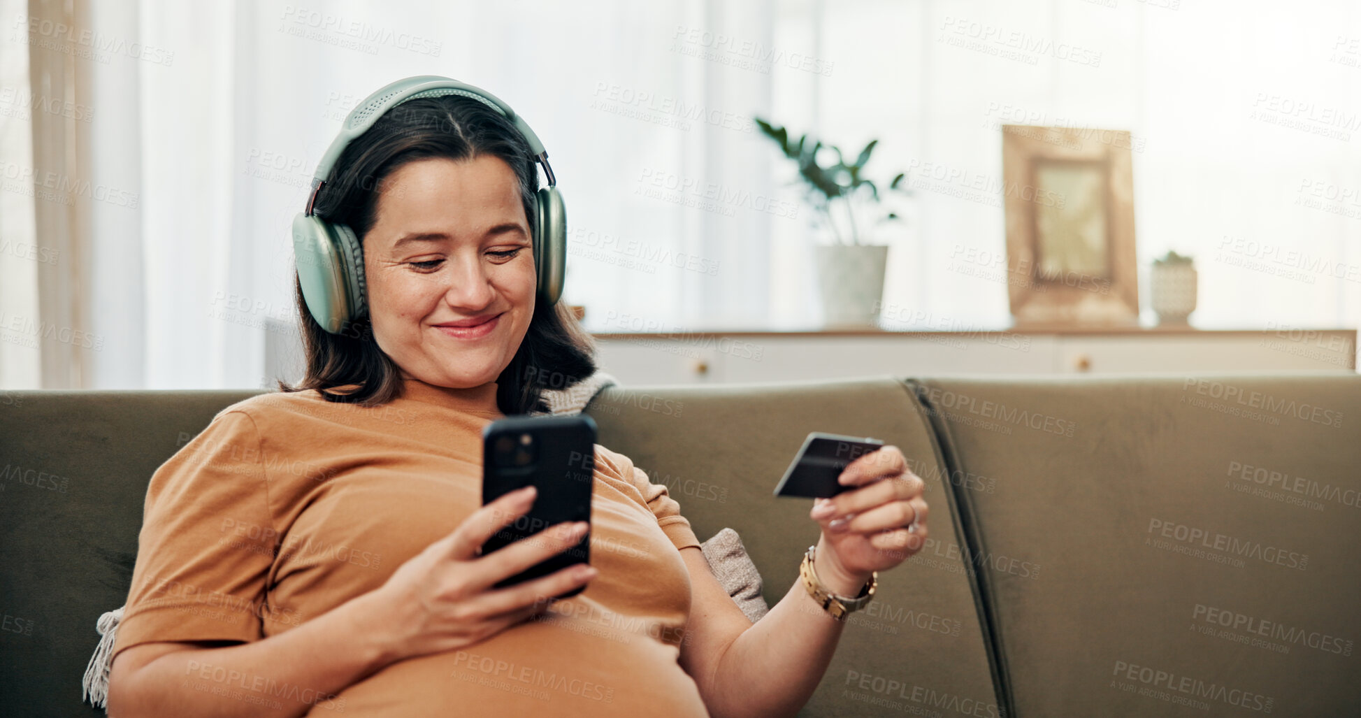 Buy stock photo Happy, pregnant woman and phone with credit card for online shopping, maternity ecommerce and payment. Person, headphones and digital with medical expenses, baby items and pregnancy podcast at house