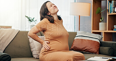 Buy stock photo Pregnant woman, back pain and stress on sofa in home with cramps, ache and fibromyalgia in living room. Person, pregnancy and frustrated on couch with sore muscle, spine and stretching in lounge