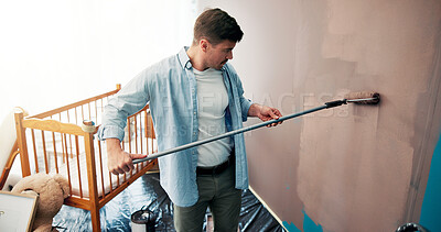 Buy stock photo Home, diy and man painting in nursery for interior design, planning and renovation in baby room. Family, future and person with roller for wall decoration, remodeling and project in new house