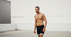Man, shirtless and training in city, outdoor and workout for muscle growth in summer, health or wellness. Person, strong and resilience for development, performance or training at urban club in Spain