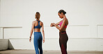 Fitness, friends and women in city with watch for training, exercise and workout outdoors. Sports, personal trainer and people with health tracking, progress app and time for performance and wellness