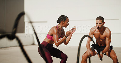 Buy stock photo Fitness, personal trainer and battle ropes for workout, exercise or health. Man, woman and bodybuilder with coach for muscle strength, energy or clapping for motivation with cardio challenge in city