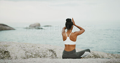Buy stock photo Ocean, calm and meditation for woman, outdoor and spiritual practice for wellness, peace and relax. Back, chakra and self awareness with person, mindfulness and yoga with prayer hands for zen
