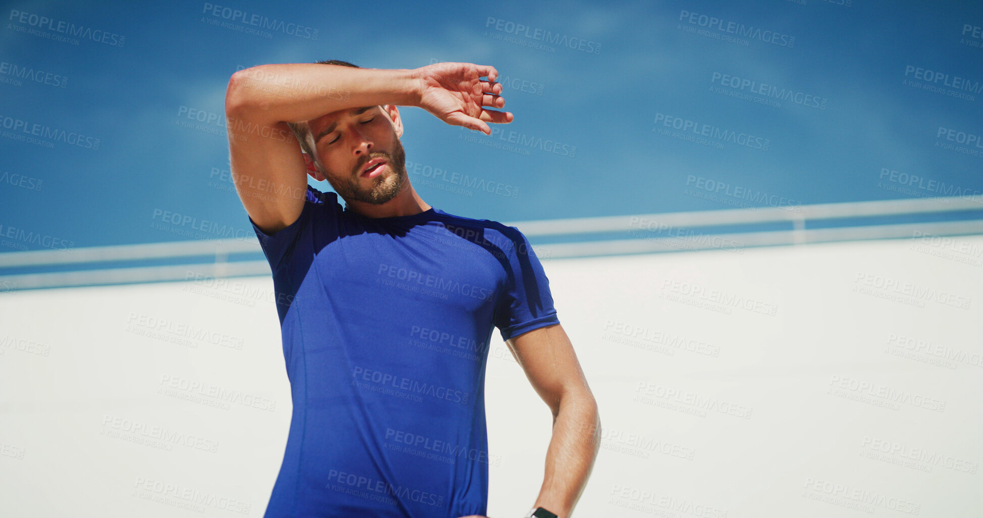 Buy stock photo Man, runner and tired on sweat, outdoor and breathing for wellness with low angle in summer. Person, athlete and training with rest, exhausted and recovery for workout, exercise and fatigue in France