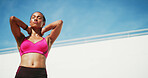 Fitness, woman and stretching with break, exercise space and sweat with wellness. Athlete, warmup and blue sky mockup for performance, body goals and serious outdoors for summer sports and balance