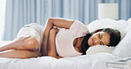 Woman, sickness and anxiety in bed with stomach pain, menstruation cramps and IBS symptoms. Girl, stress and health risk in home bedroom with tummy ache, endometriosis and fetal position for relief