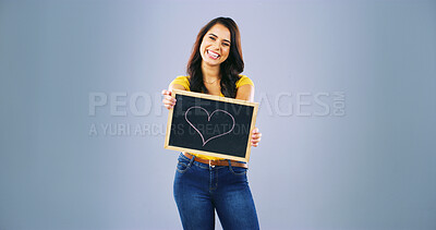 Buy stock photo Portrait, smile and woman with heart on black board of self love, spread kindness and celebrate moments. Person, sign and space for advertising romance, passion and happiness in studio background
