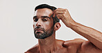 Portrait, man and tweezer for hair removal in studio for beauty, maintenance and facial growth. Person, tools and grooming routine of eyebrow hygiene, self care and transformation on white background