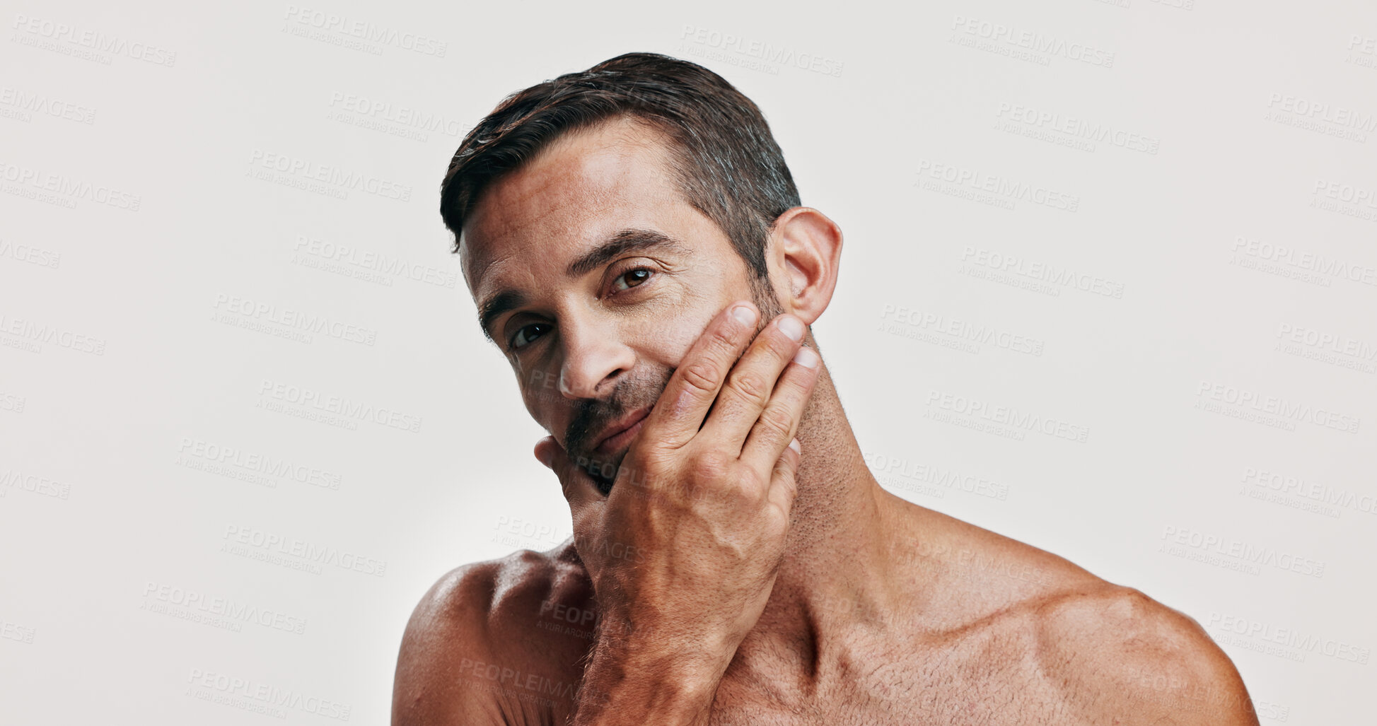 Buy stock photo Beauty, inspection and portrait of man in studio for antiaging treatment or dermatology. Aesthetic, cosmetics and skincare model checking face, isolated on white background for self care routine