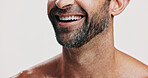 Happy, mouth and beard of man on a white background for wellness, health and cosmetics for grooming. Dermatology, skincare and face closeup of person for hygiene, facial and dental smile in studio