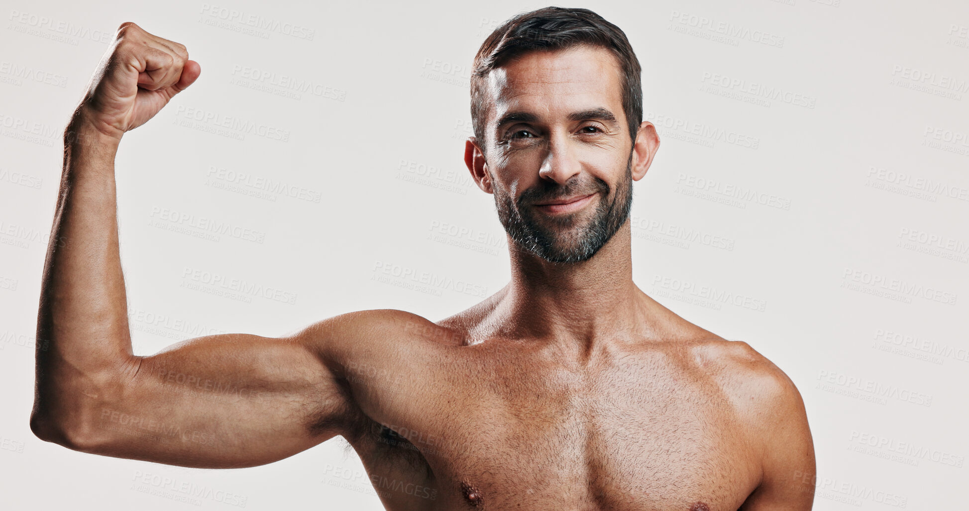Buy stock photo Arm muscles, flexing and portrait of man in studio with body building workout for fitness progress. Happy, biceps and male person with strength for power training or exercise by white background.
