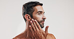 Man, touch and beard for skincare in studio with facial glow,  natural cosmetic and treatment results. Male person, beauty and hair growth for grooming routine, dermatology shine and white background