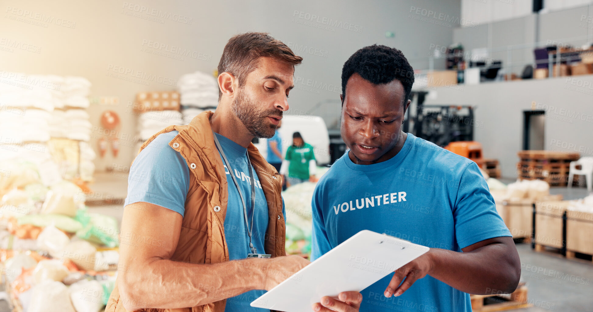 Buy stock photo Men, volunteer and talk with clipboard at warehouse for donation stock, inventory checklist and charity. People, team and grocery notes for humanitarian aid, ngo welfare and food list of distribution