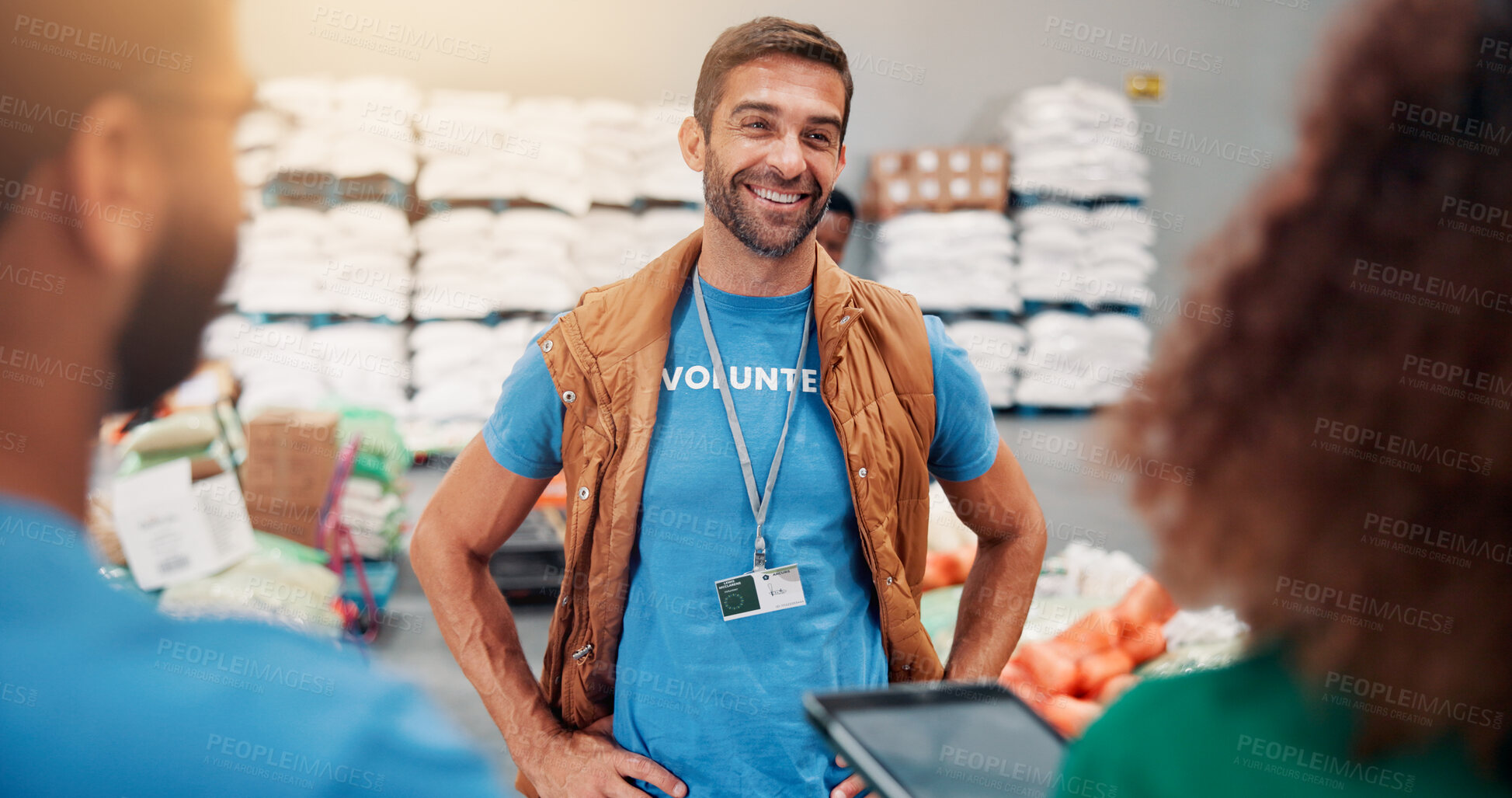 Buy stock photo Helping, charity and people with tablet, smile and review of donations on website or discussion. Social responsibility, volunteers and group in warehouse with coordinator for community service or NGO