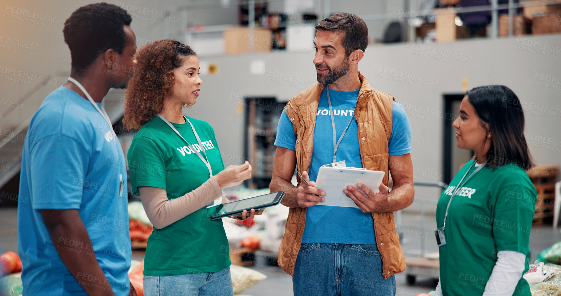 Buy stock photo Talking, charity and people with clipboard , smile and review of donations on tablet and inventory. Social responsibility, volunteers and group in warehouse with coordinator for community service