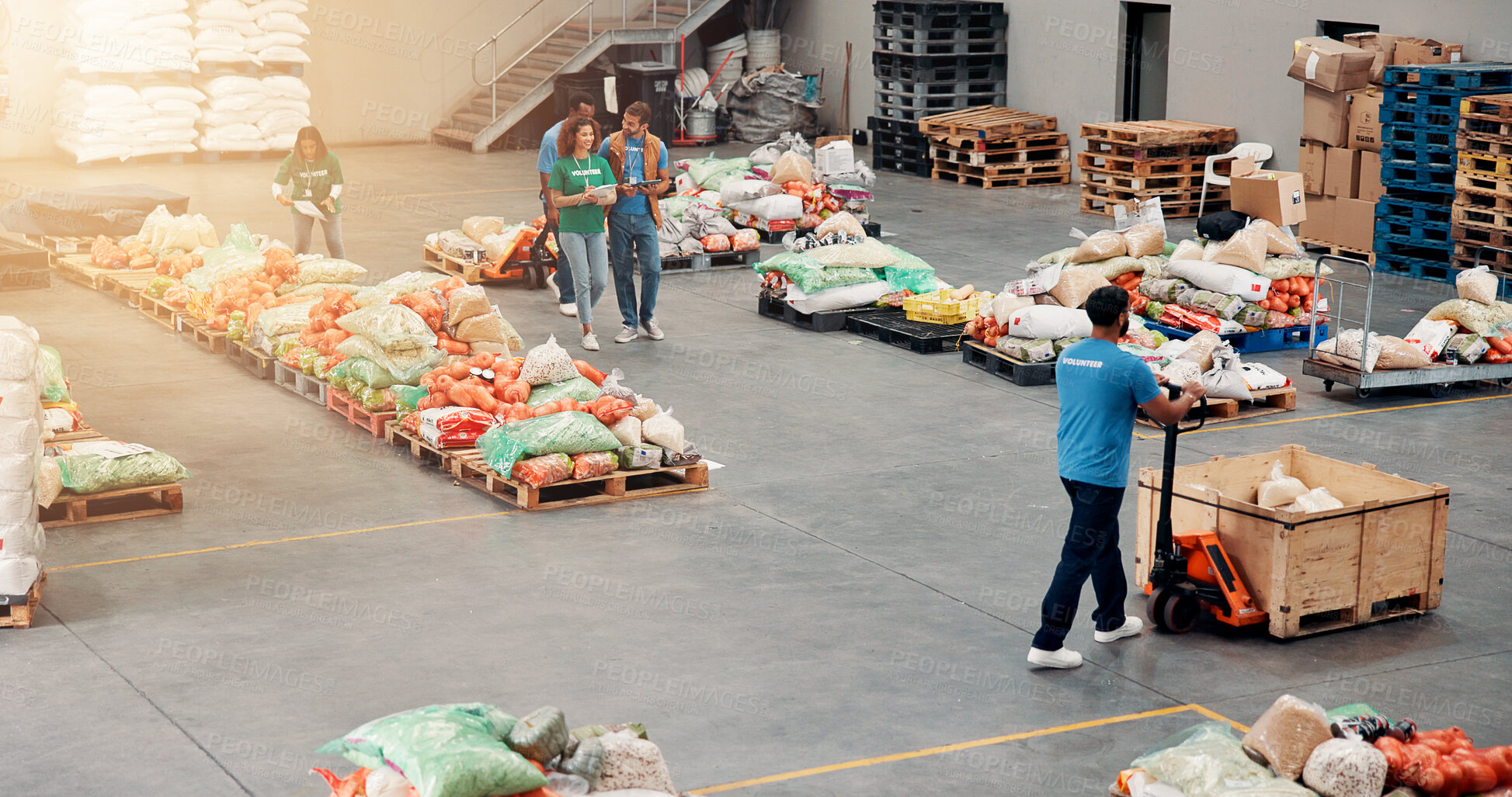 Buy stock photo People, volunteering and food distribution at warehouse, community charity and humanitarian aid. Staff, helping and machine with groceries for courier services, homeless donation and parcel logistics