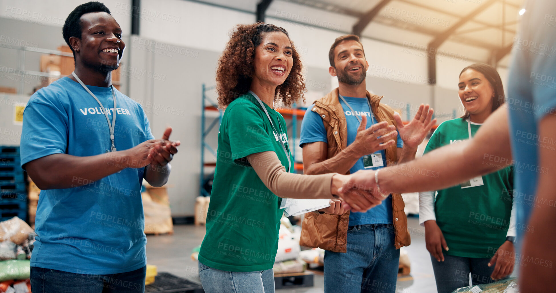 Buy stock photo Applause, handshake and support with volunteer team in warehouse together for aid, community or welfare. Agreement, charity and donation with people shaking hands for ngo or non profit success