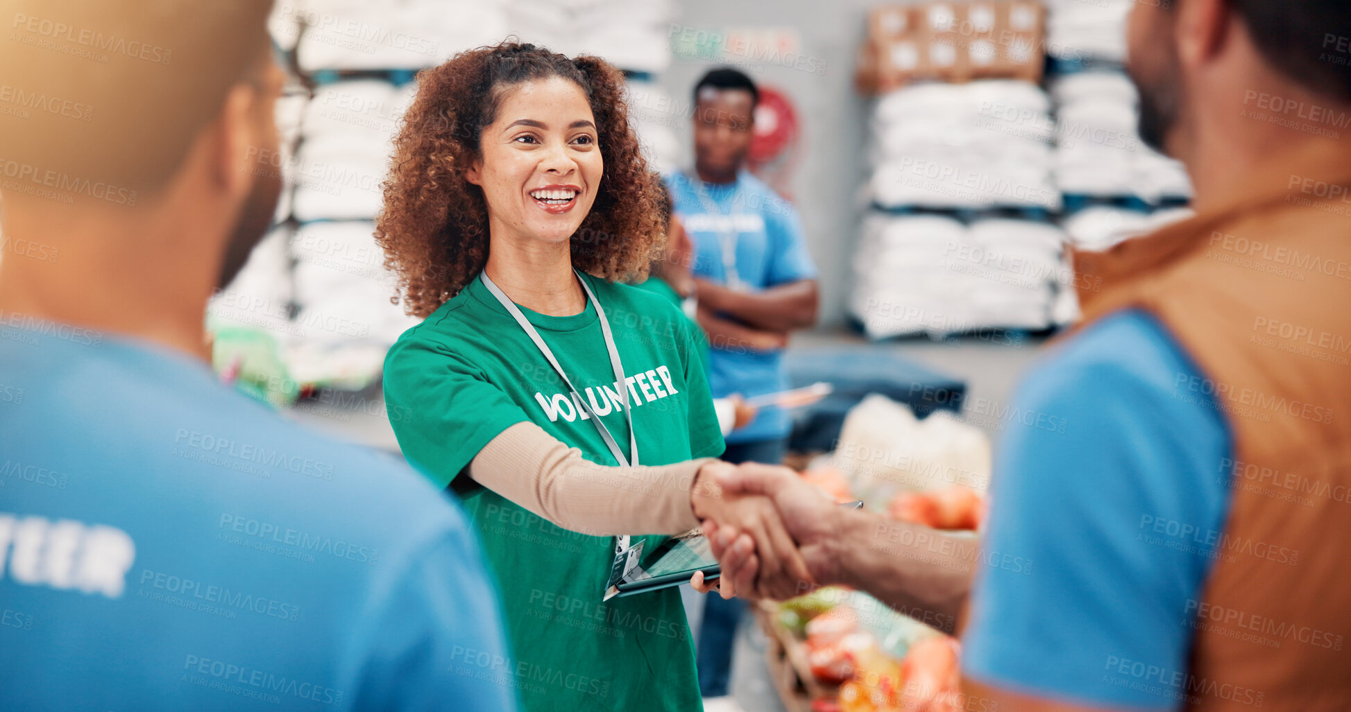 Buy stock photo People, charity and smile for handshake, volunteers and happy to help with donations and collaboration. Social responsibility, tablet and group in warehouse with supplies for community service or NGO
