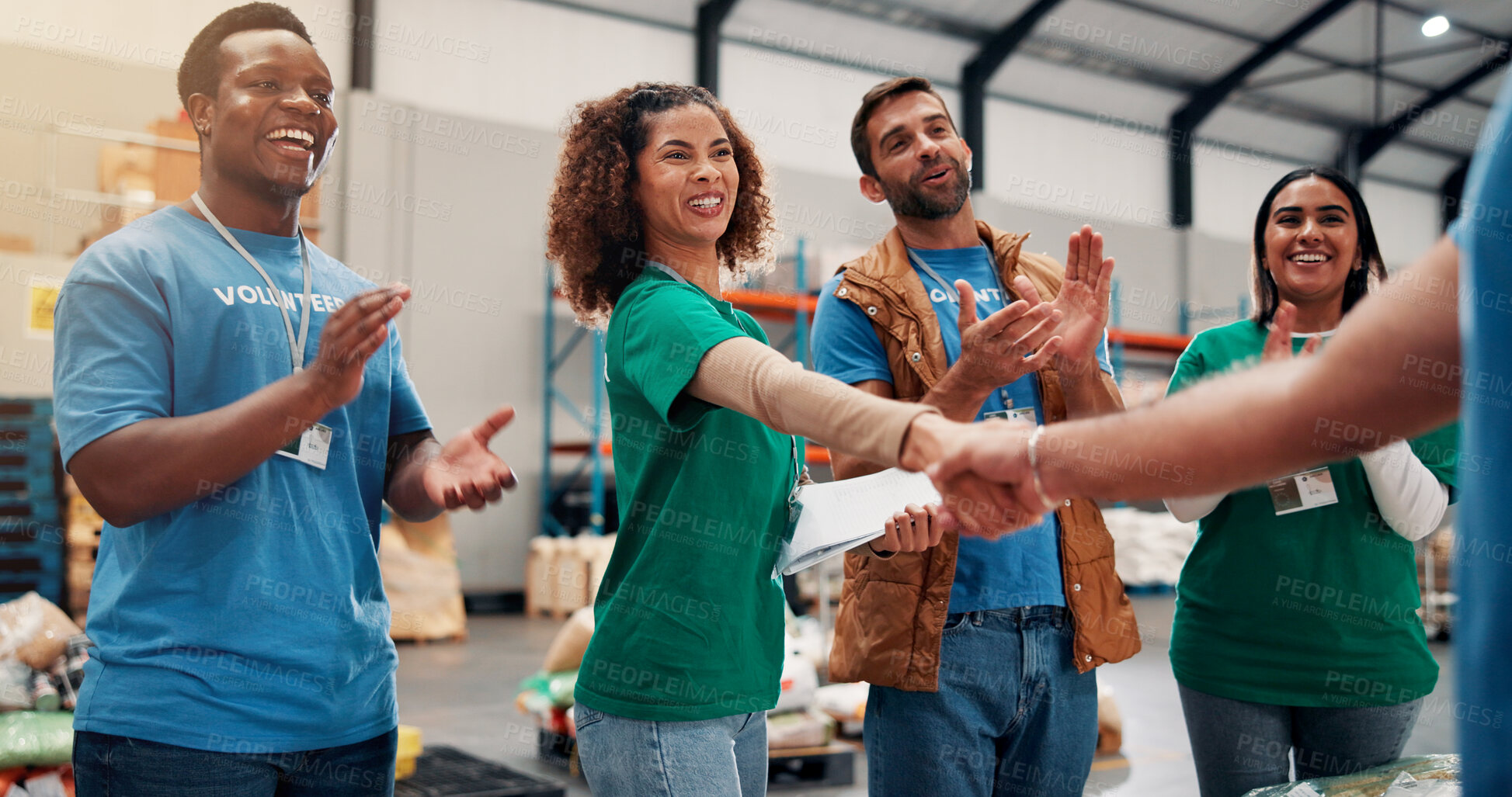 Buy stock photo Applause, handshake and success with volunteer team in warehouse together for aid, community or welfare. Charity, donation and support with people shaking hands for ngo or non profit agreement