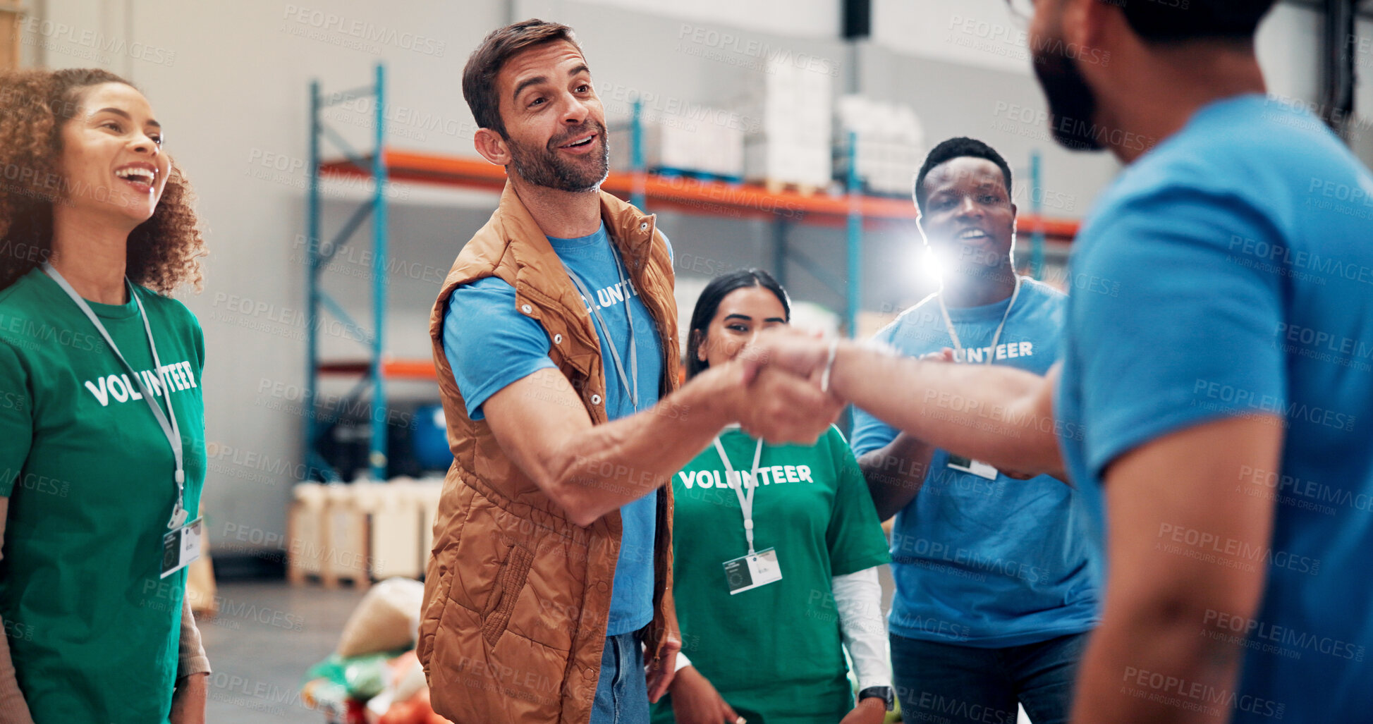 Buy stock photo Deal, handshake and support with volunteer team in warehouse together for aid, community service or welfare. Charity, collaboration and donation with people shaking hands for non profit success
