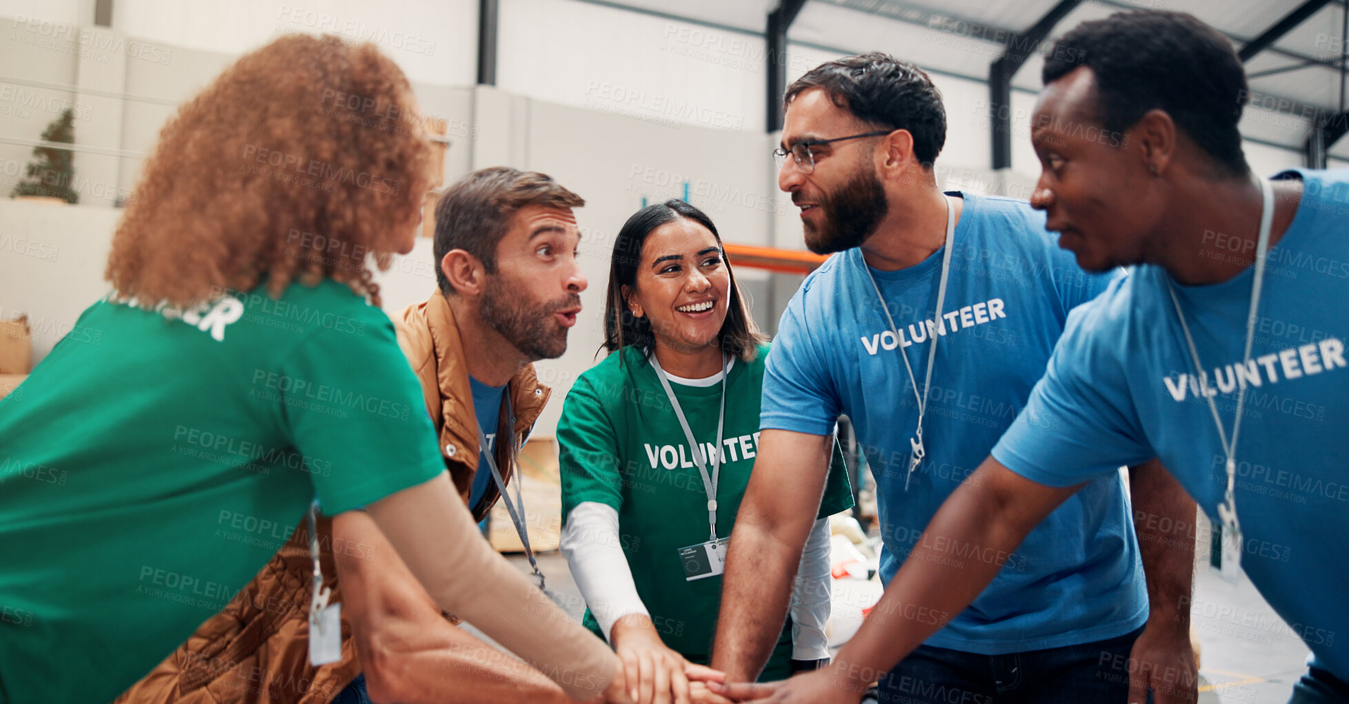 Buy stock photo Huddle, motivation and support with volunteer team in warehouse together for aid, community or welfare. Charity, donation and stack of hands with people in circle for ngo or non profit success