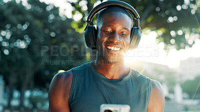 Buy stock photo Fitness, headphones and black man on mobile for music, streaming hip hop or sound. Happy athlete, phone and listening to radio outdoor for exercise podcast, audio or motivation playlist on internet