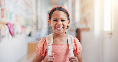 Buy stock photo Happy, backpack and portrait of kid in school for learning, development or growth on campus. Pride, child and face of girl student in hallway for education, studying or lesson at kindergarten academy