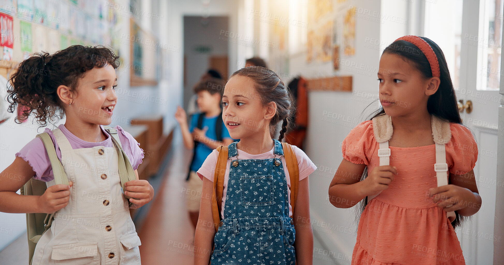 Buy stock photo Children, friends and talking in corridor at school for education, learning or recess. Happy girls, classmates and students walk to class together for development, knowledge or growth in elementary