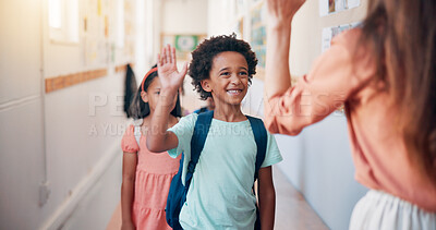 Buy stock photo Teacher, children and high five at school, happy and welcome to classroom for education in morning. Boy, smile and greeting with motivation for learning, scholarship and excited in hallway at academy