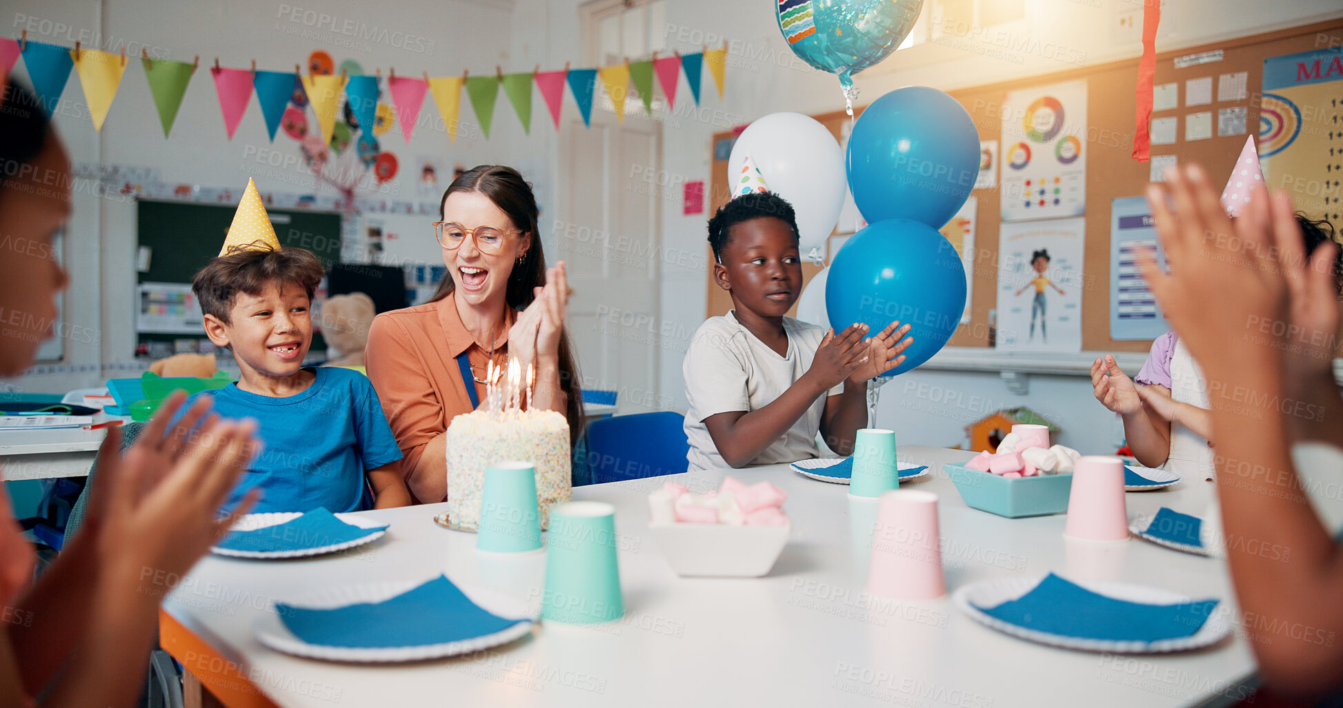 Buy stock photo Birthday, cheering and children with teacher in classroom for group party with cake, hats and decoration. Happy, clapping hands and woman educator with kid students for celebration of special event.
