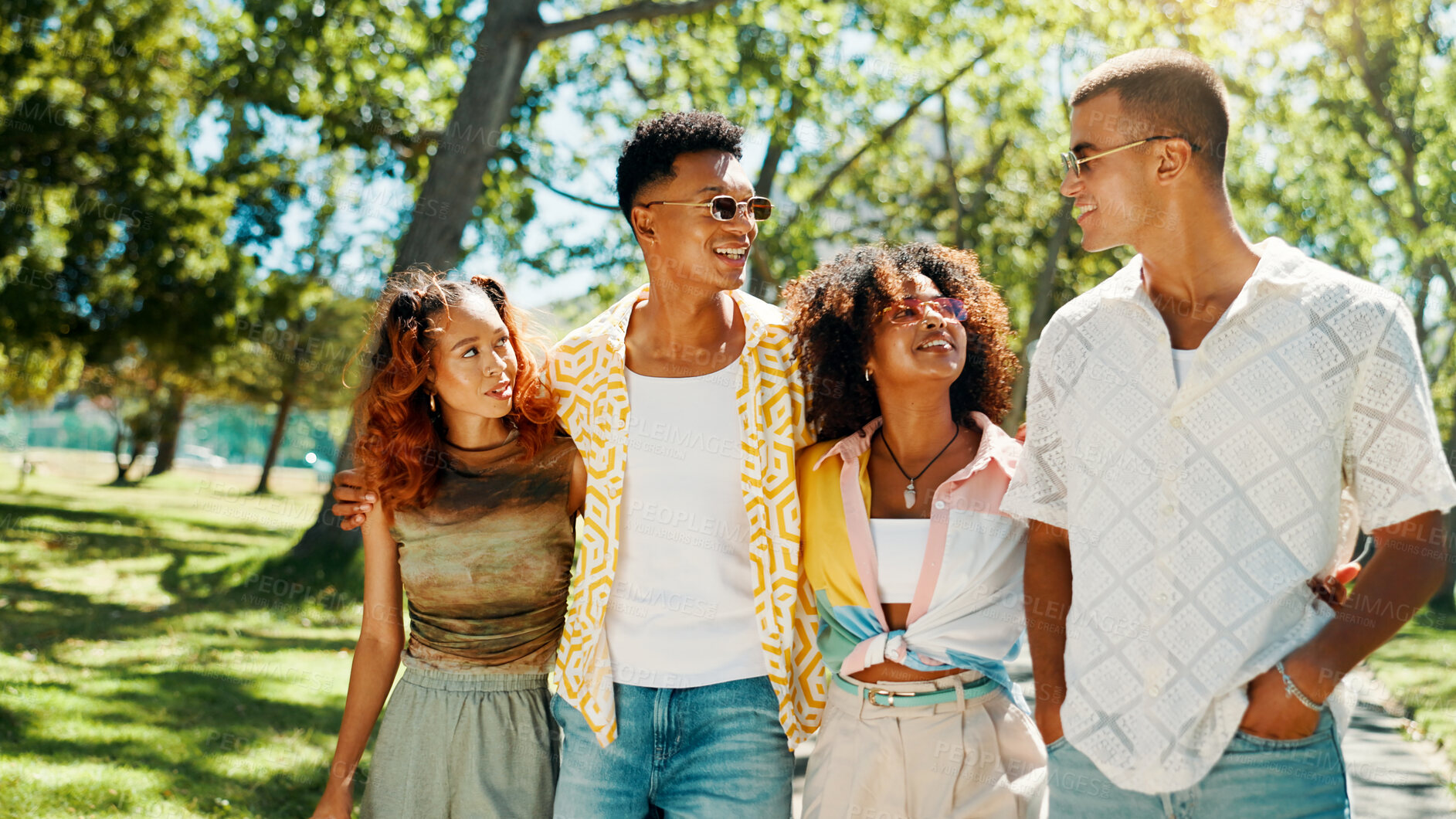Buy stock photo Happy, group and friends walk at park with social gathering, university break and bonding together. Couple of people, talking and embrace with summer vacation, travel and reunion for streetwear style